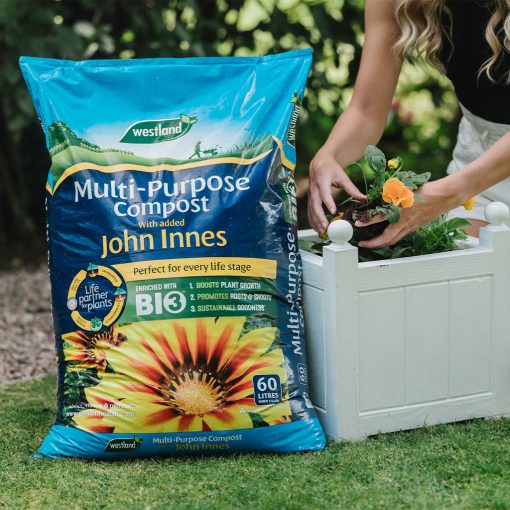 Westland Multi Purpose Compost With John Innes 60 Litre being used to plant a potted plant